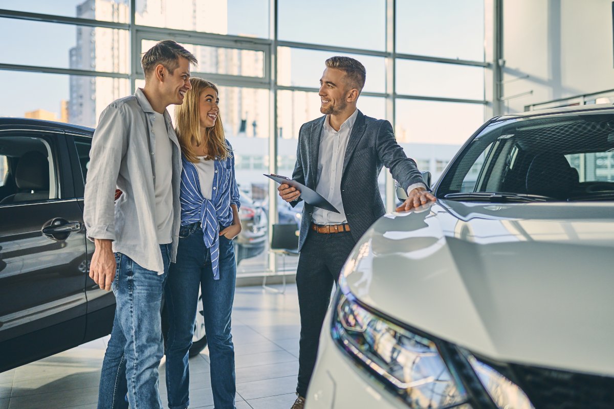 Couple purchasing car from salesperson.