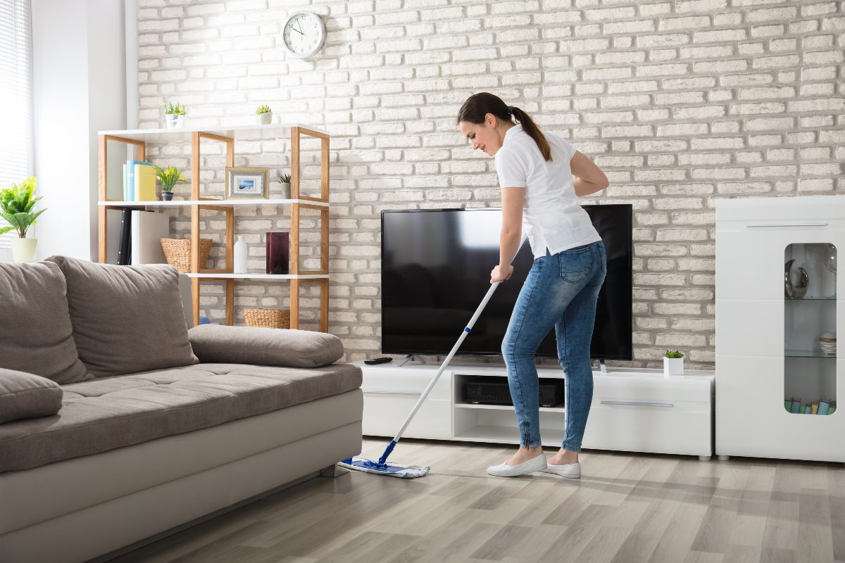 Young adult cleaning home.