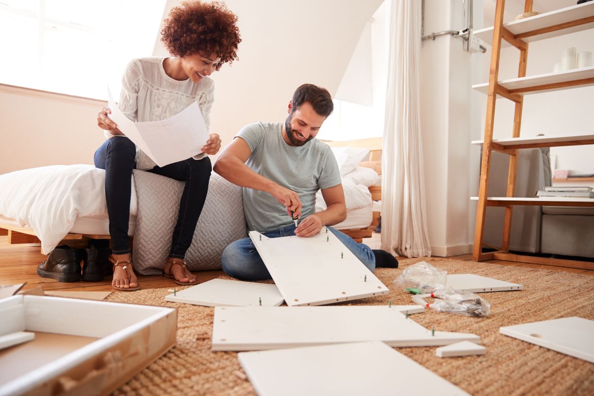 Couple constructing furniture.