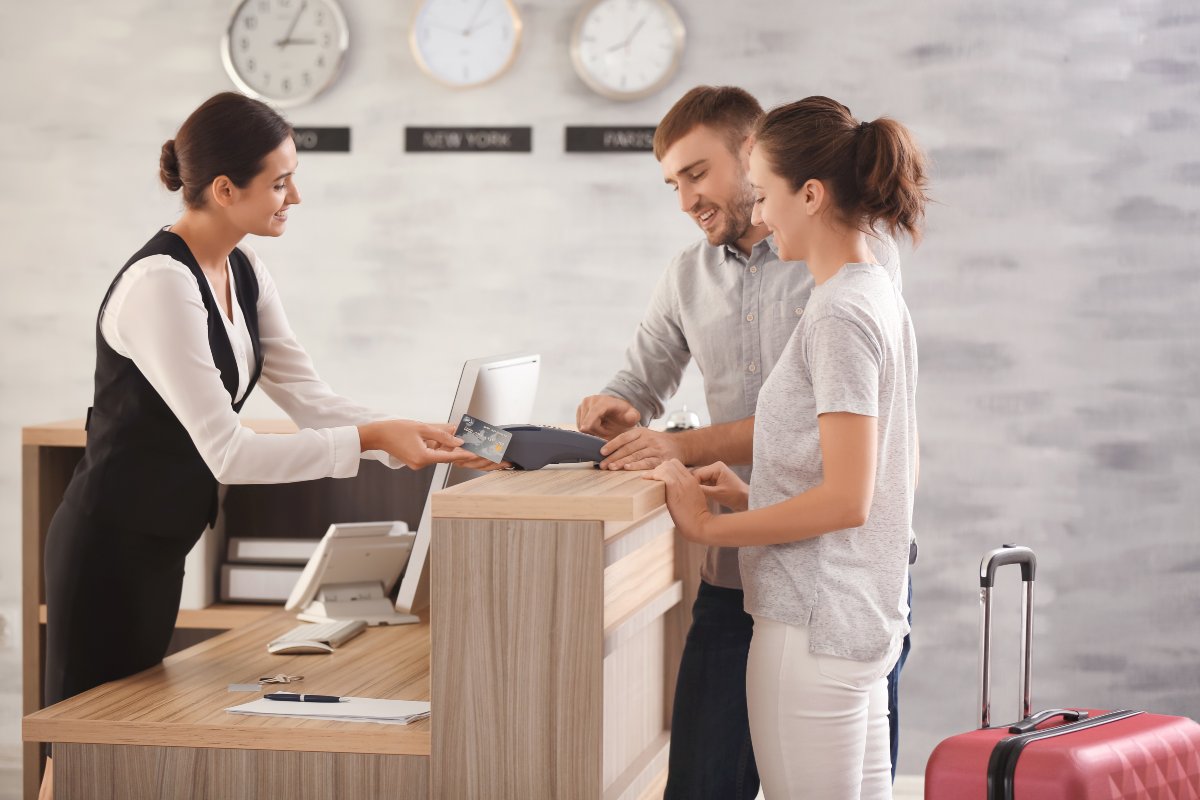 Couple checking in at a hotel.