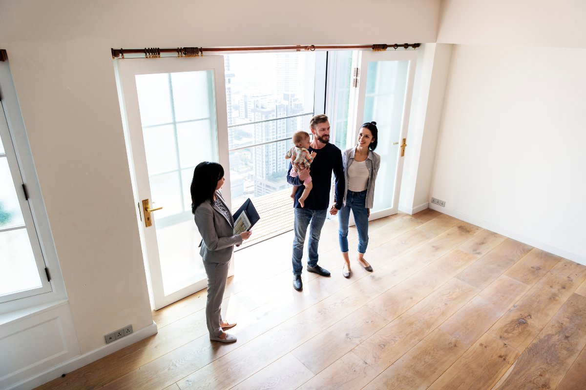 Young family at an open house with agent.