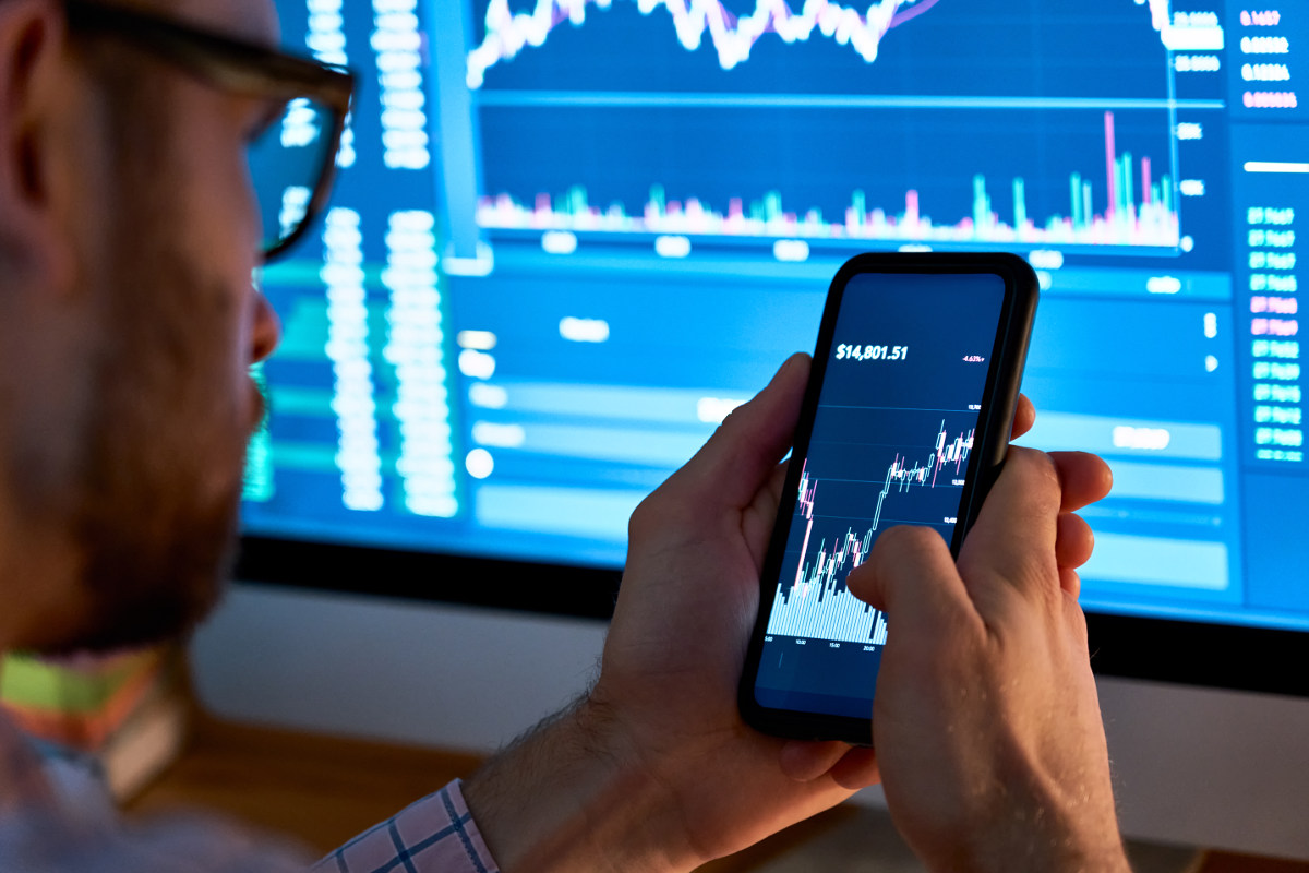 Man purchasing cryptocurrency through his phone.