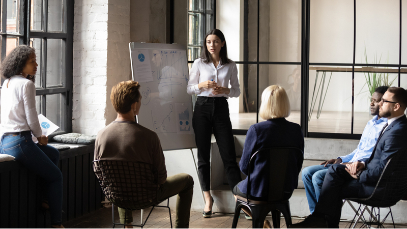 Business professional leading a team discussion.