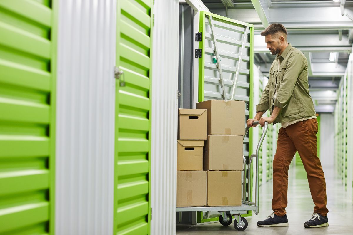 Individual moving boxes into storage unit.