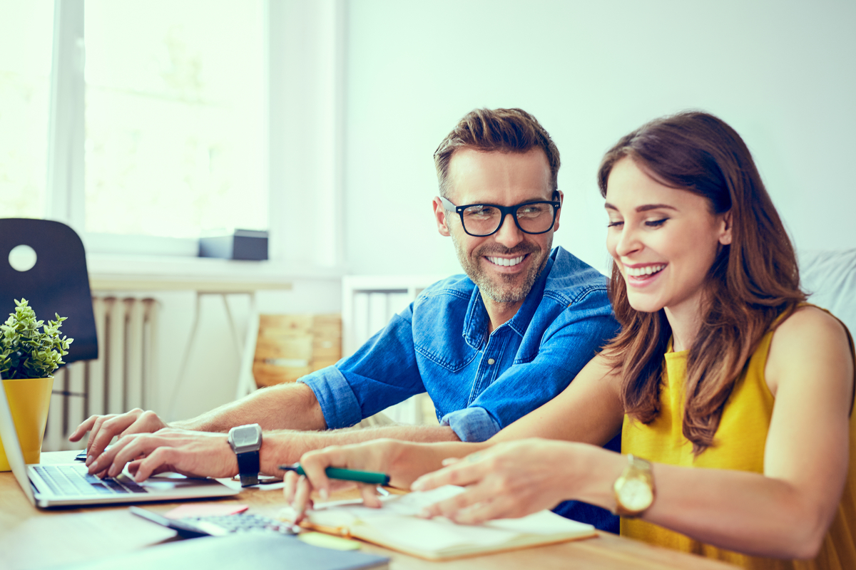 Man and woman figuring out the monthly cost of a loan.